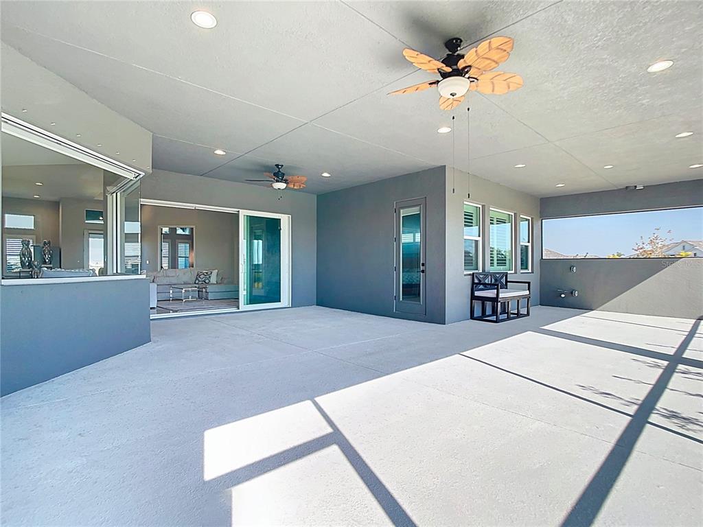 3586 Recurve Circle Sarasota, FL 34240 - Photo 48 of 65 a large bedroom with a large bed and chandelier