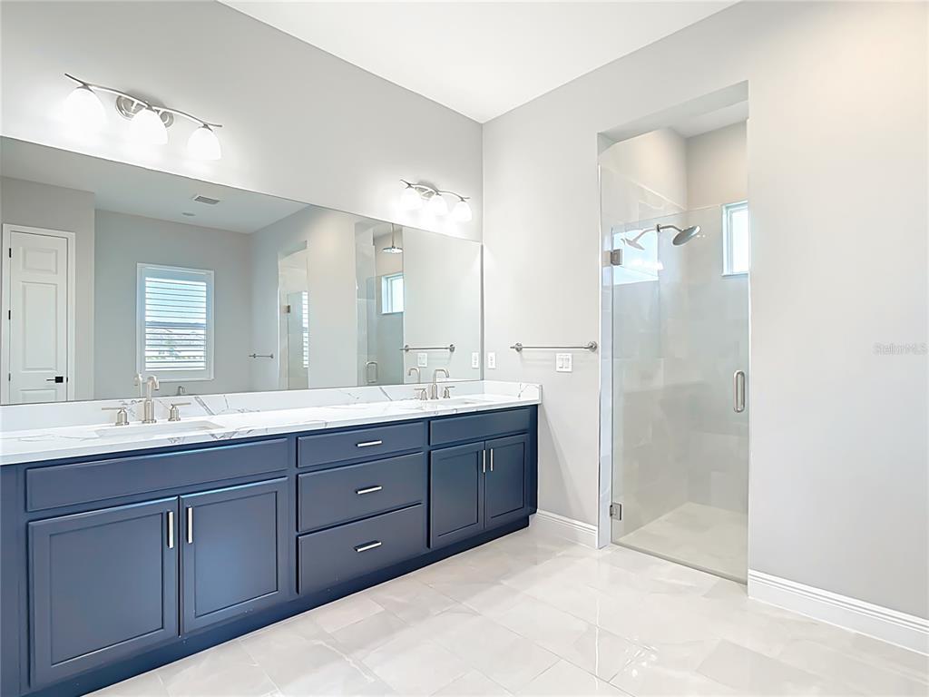 3586 Recurve Circle Sarasota, FL 34240 - Photo 5 of 66 a bathroom with double vanity sinks and a shower
