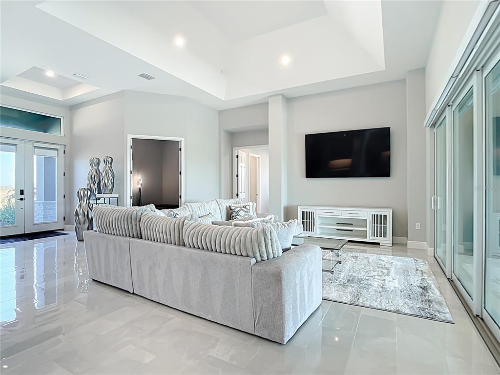 3586 Recurve Circle Sarasota, FL 34240 - Photo 7 of 66 a living room with furniture and a flat screen tv