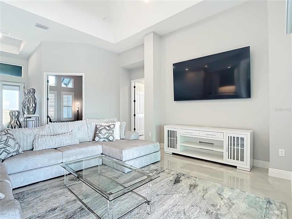 3586 Recurve Circle Sarasota, FL 34240 - Photo 8 of 66 a living room with furniture and a flat screen tv