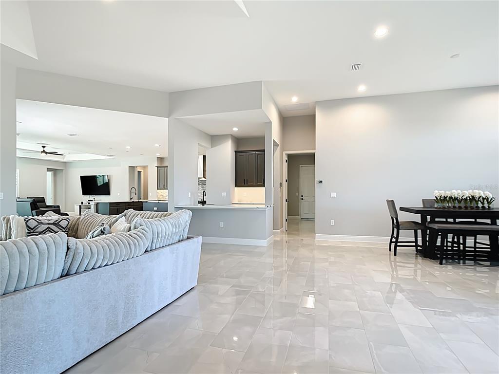 3586 Recurve Circle Sarasota, FL 34240 - Photo 10 of 66 a living room with furniture and a dining table with kitchen view