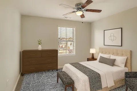 a bedroom with a bed and a painting on the wall
