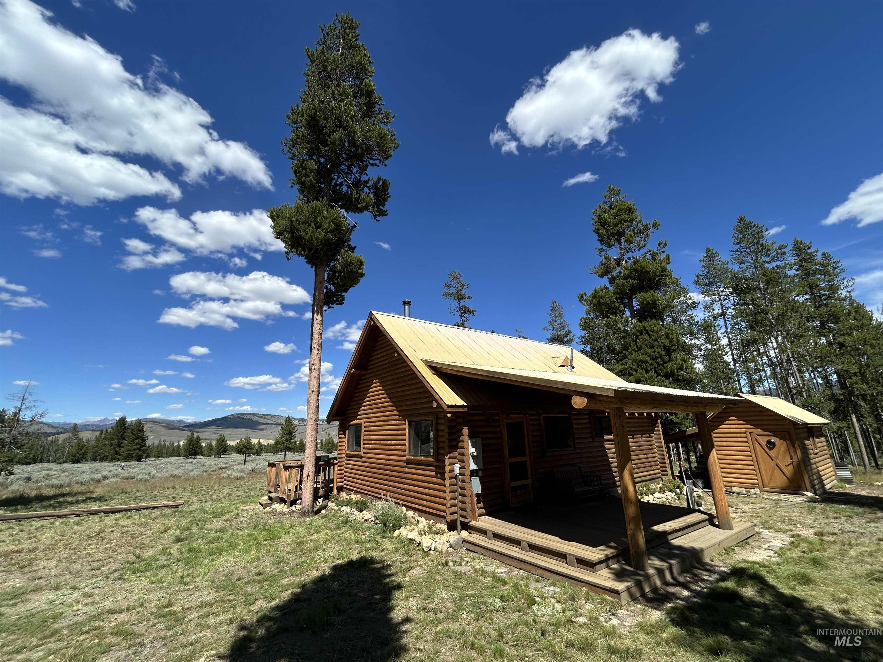 35 Sawtooth Way Stanley, ID 83278 - Photo 5 of 36 Log cabin exterior featuring a covered porch, log siding, and a metal roof