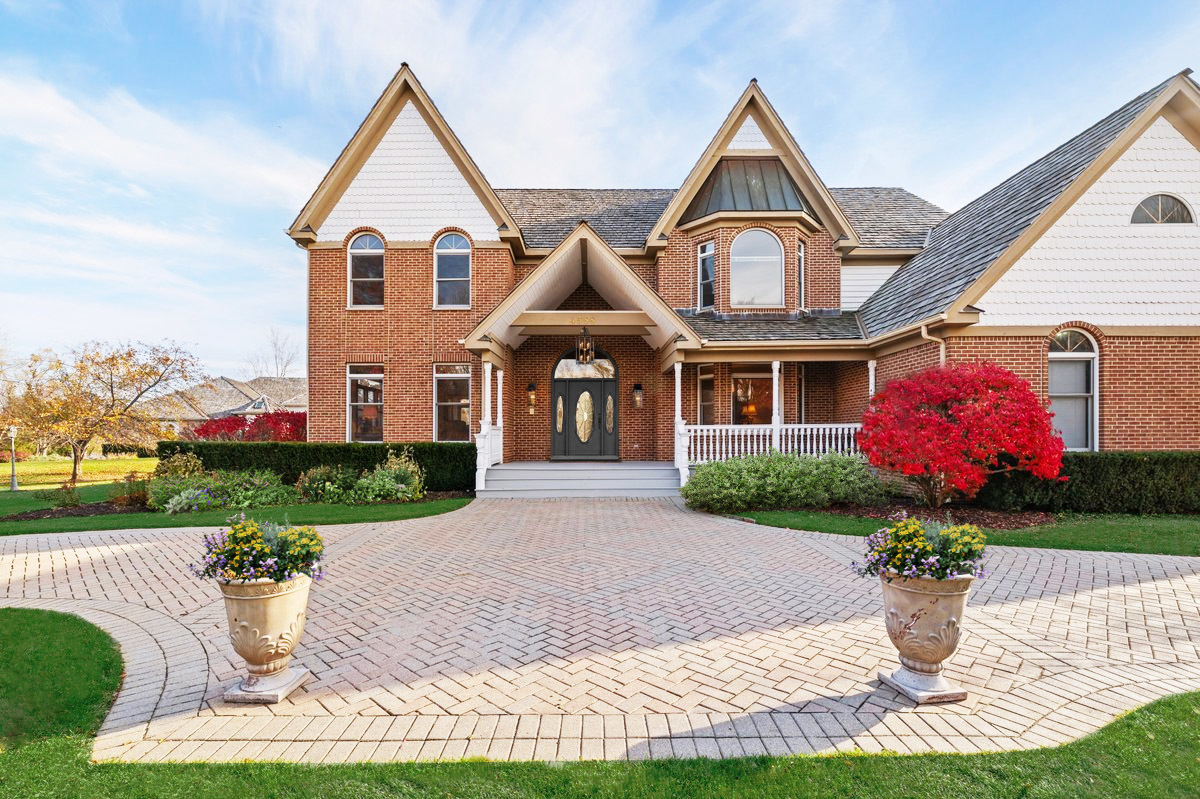 4588 Pamela Court Long Grove, IL 60047 - Photo 2 of 59 a front view of a house with a yard and potted plants