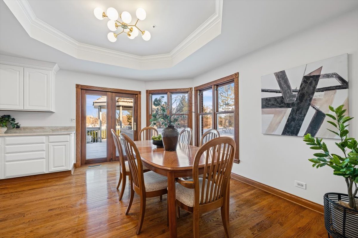 4588 Pamela Court Long Grove, IL 60047 - Photo 22 of 59 a view of a dining room with furniture window and wooden floor