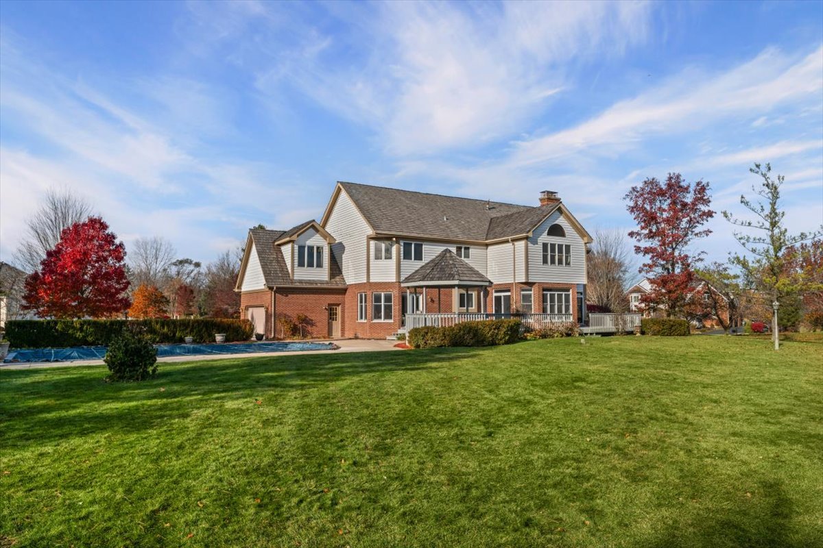 4588 Pamela Court Long Grove, IL 60047 - Photo 56 of 59 a front view of a house with a garden and trees