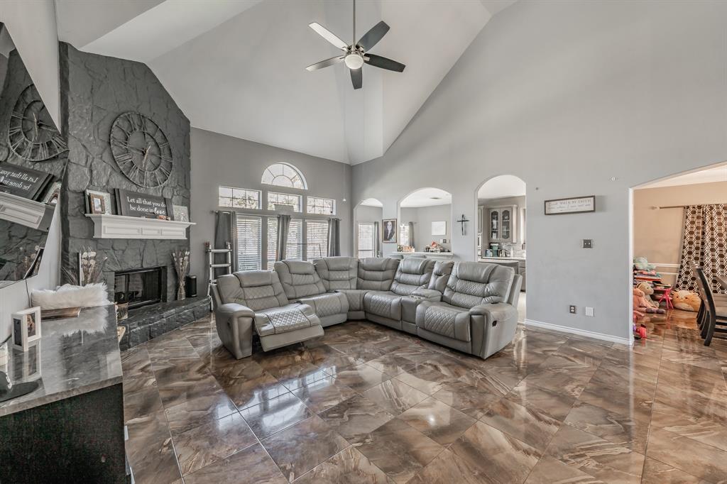 5243 West Cove Way Grand Prairie, TX 75052 - Photo 11 of 38 a living room with furniture a fireplace and a flat screen tv