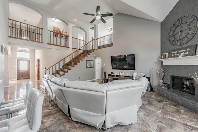 a living room with furniture a flat screen tv and a fireplace