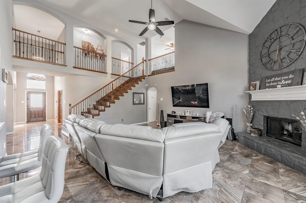 5243 West Cove Way Grand Prairie, TX 75052 - Photo 12 of 38 a living room with furniture a flat screen tv and a fireplace