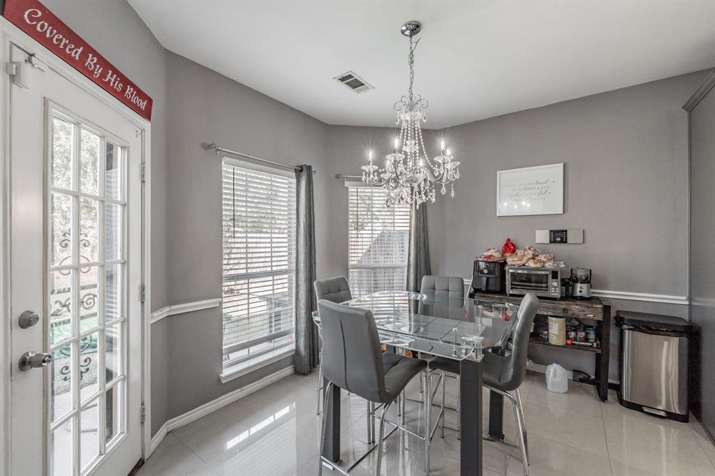 5243 West Cove Way Grand Prairie, TX 75052 - Photo 13 of 38 a view of a dining room with furniture a chandelier and window