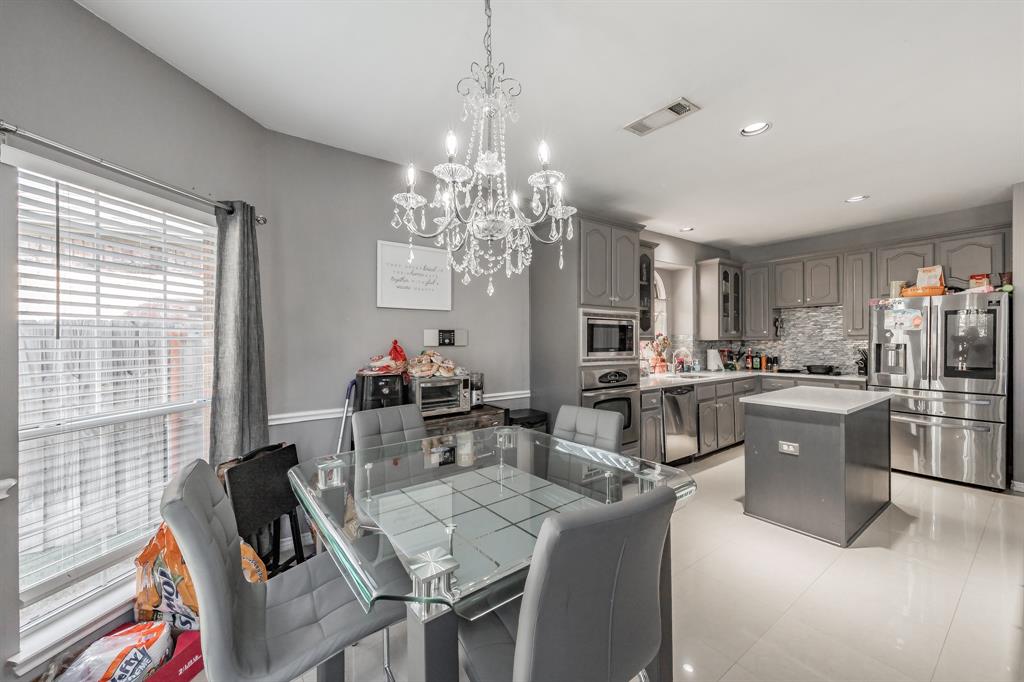 5243 West Cove Way Grand Prairie, TX 75052 - Photo 14 of 38 a view of a dining room with furniture and chandelier