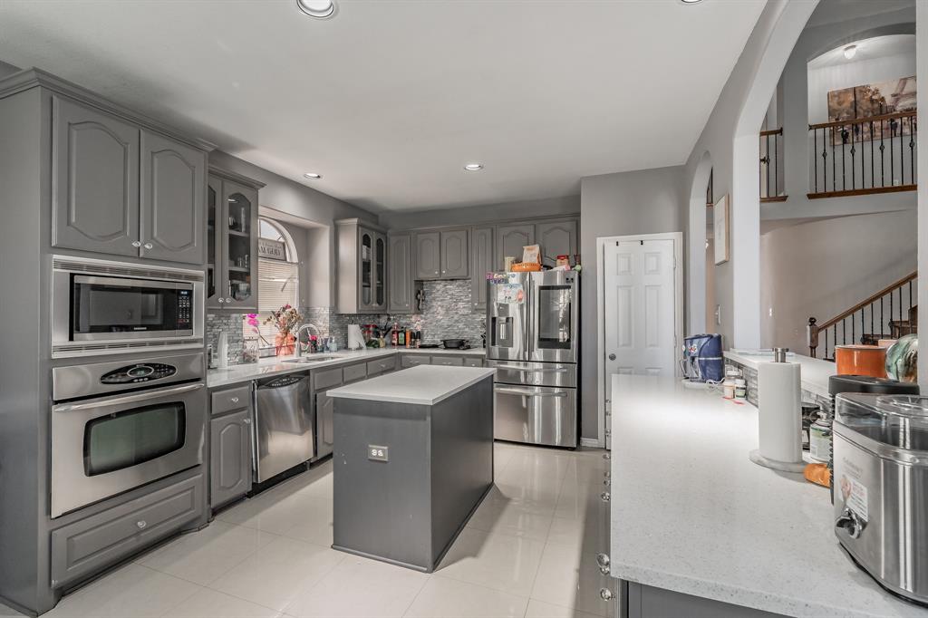 5243 West Cove Way Grand Prairie, TX 75052 - Photo 15 of 38 a kitchen with refrigerator and cabinets