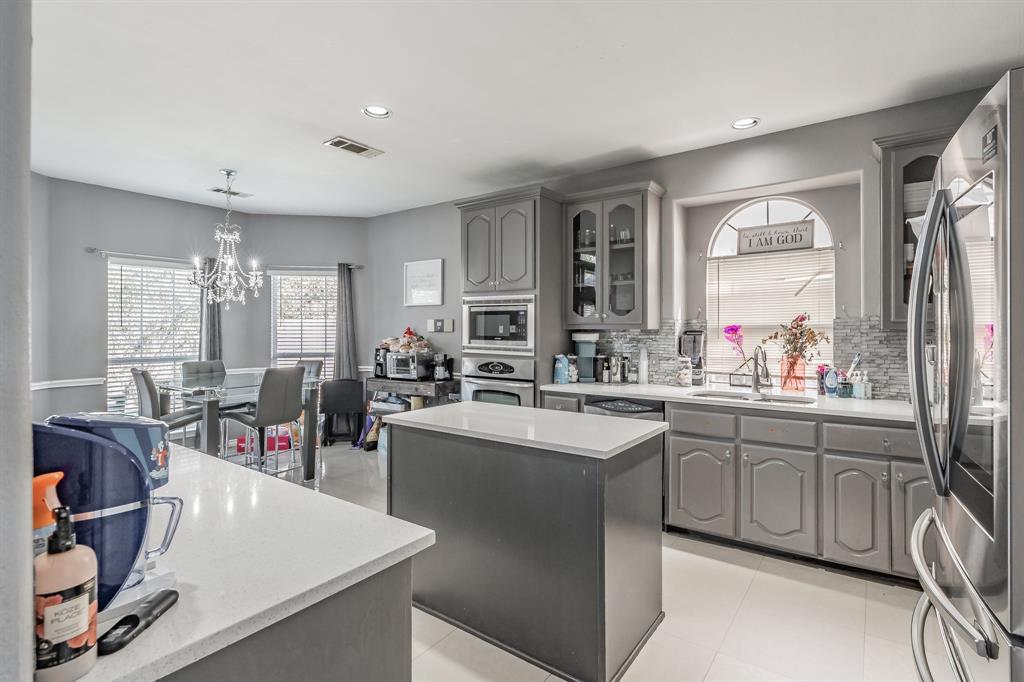 5243 West Cove Way Grand Prairie, TX 75052 - Photo 17 of 38 a large kitchen with lots of counter space sink and a refrigerator