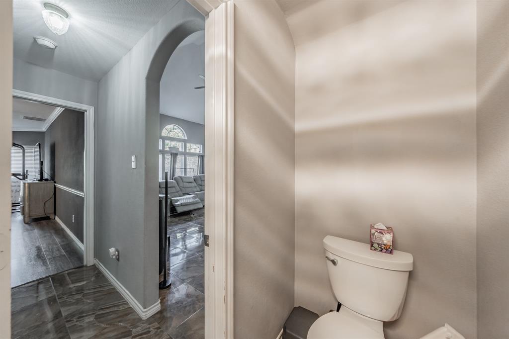 5243 West Cove Way Grand Prairie, TX 75052 - Photo 19 of 38 a bathroom with a toilet sink and mirror