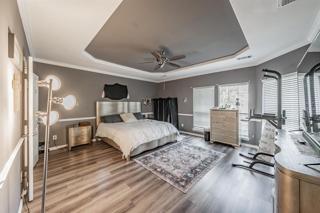 5243 West Cove Way Grand Prairie, TX 75052 - Photo 20 of 38 a bedroom with a bed and a chandelier