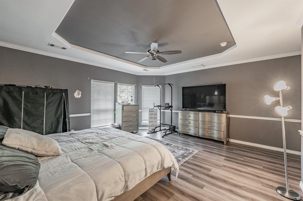 5243 West Cove Way Grand Prairie, TX 75052 - Photo 21 of 38 a bedroom with a bed and a flat screen tv