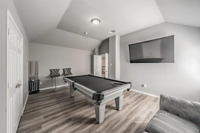 a view of a room with wooden floor and furniture