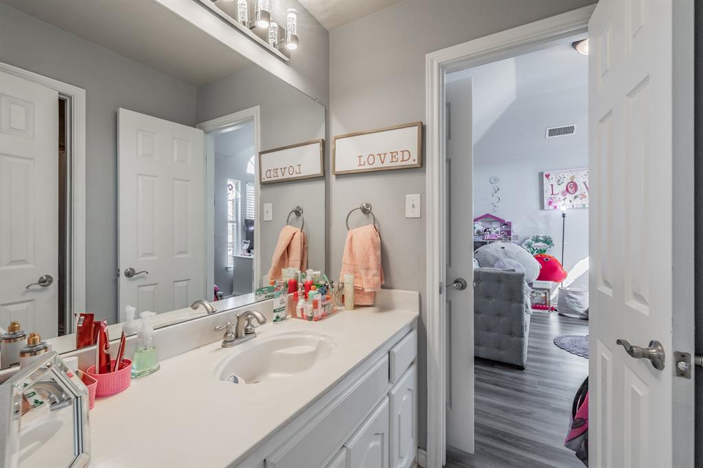 5243 West Cove Way Grand Prairie, TX 75052 - Photo 32 of 38 a bathroom with a sink mirror and shower
