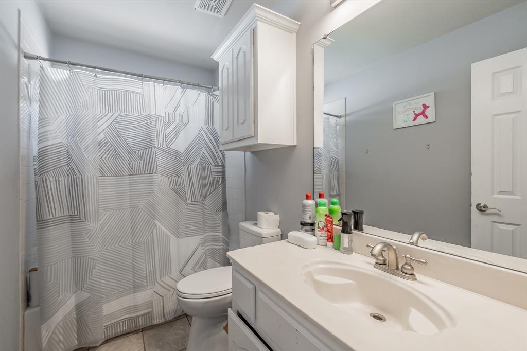 5243 West Cove Way Grand Prairie, TX 75052 - Photo 35 of 38 a bathroom with a sink a toilet and shower