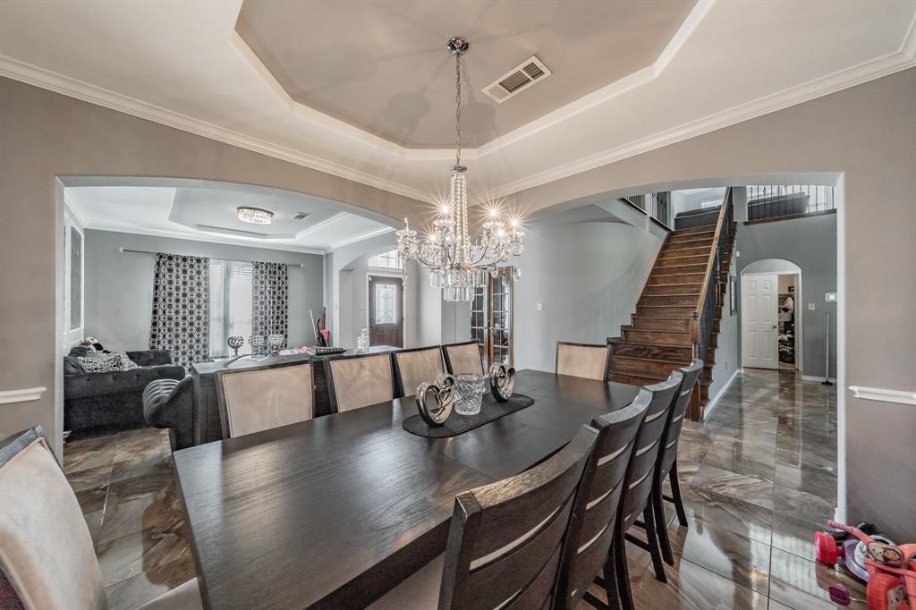 5243 West Cove Way Grand Prairie, TX 75052 - Photo 8 of 38 a view of a dining room with furniture and wooden floor