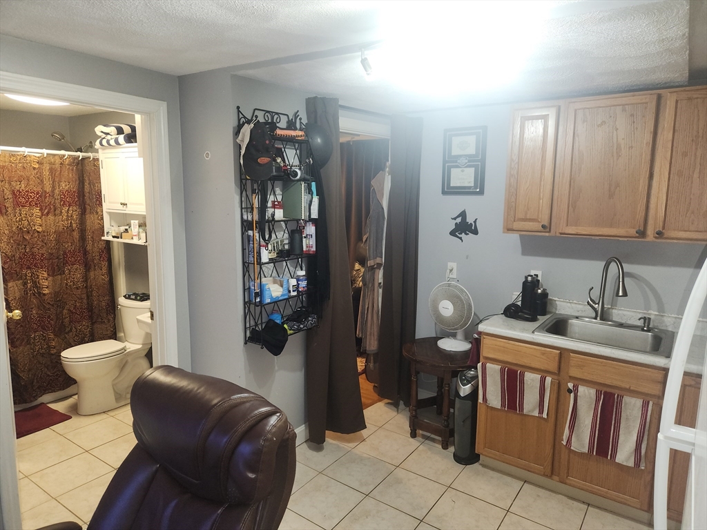 81 Cabot Street, Unit 1M Beverly, MA 01915 - Photo 2 of 13 a bathroom with a toilet a sink and shower