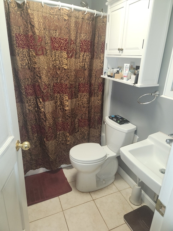 81 Cabot Street, Unit 1M Beverly, MA 01915 - Photo 4 of 13 a bathroom with a toilet and a shower