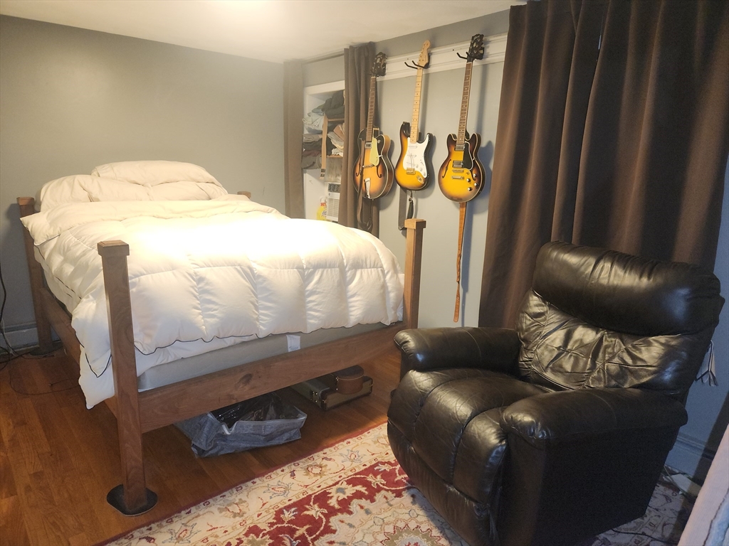 81 Cabot Street, Unit 1M Beverly, MA 01915 - Photo 7 of 13 a bedroom with a bed dresser and a window