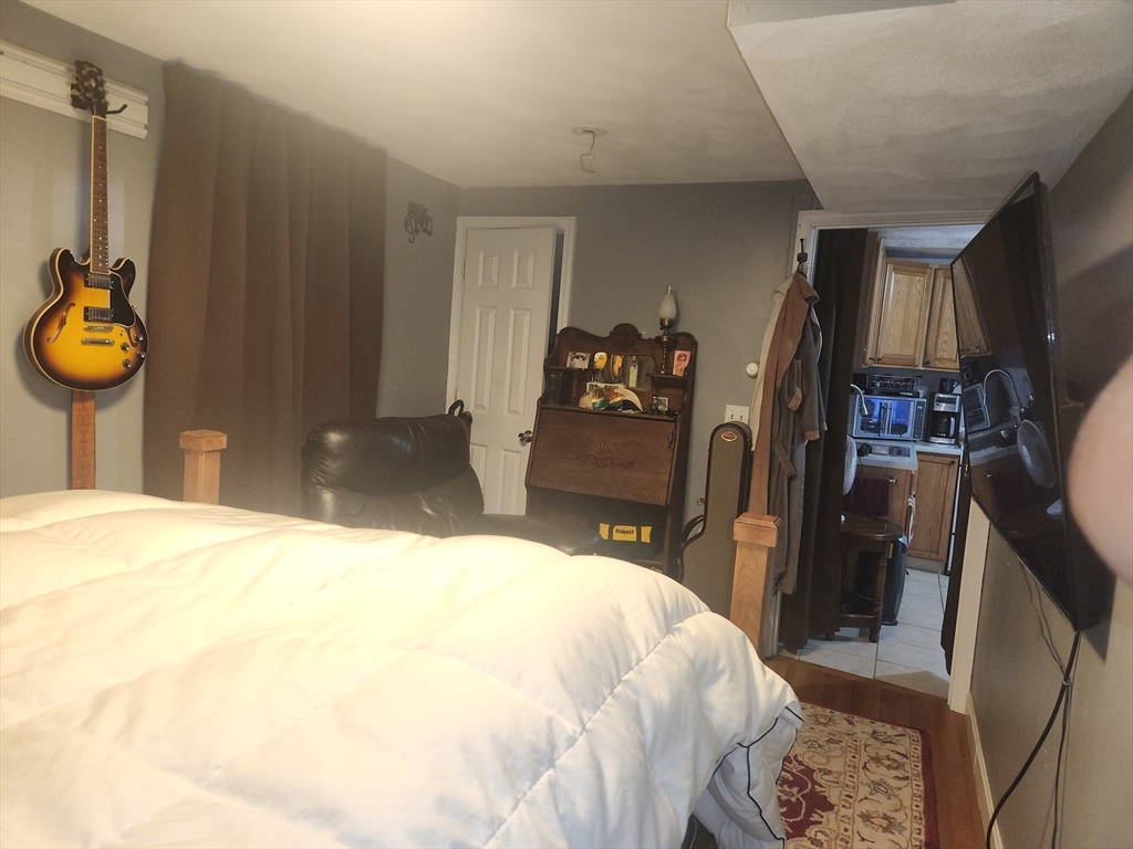 81 Cabot Street, Unit 1M Beverly, MA 01915 - Photo 8 of 13 a bedroom with a bed a mirror and closet