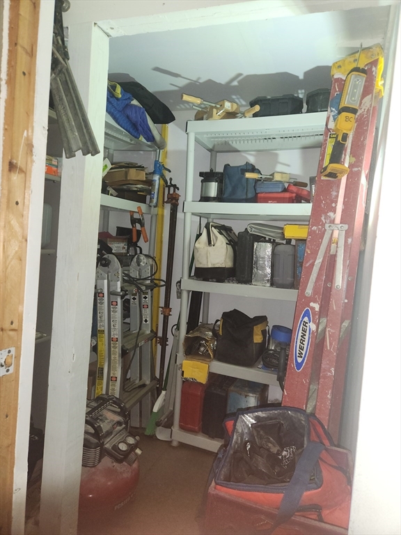 81 Cabot Street, Unit 1M Beverly, MA 01915 - Photo 10 of 13 a view of walk in closet with clothes and shoes