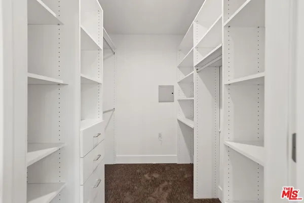 a view of walk in closet with white walls