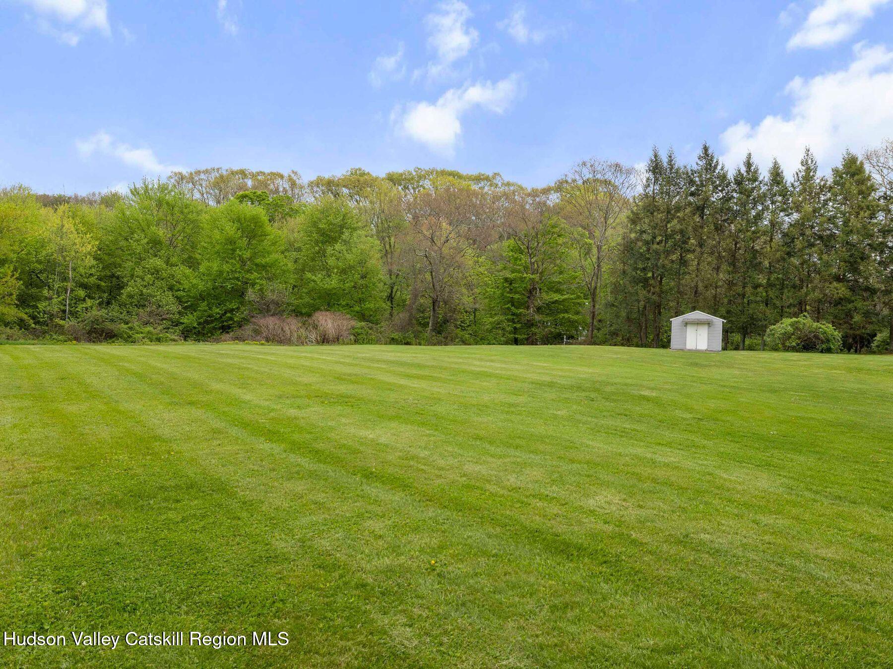 104 New Paltz Road Highland, NY 12528 - Photo 35 of 43 a backyard of a house with lots of green space and mountain view