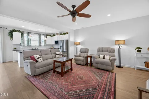 a kitchen with stainless steel appliances granite countertop a kitchen island a stove and a wooden floors