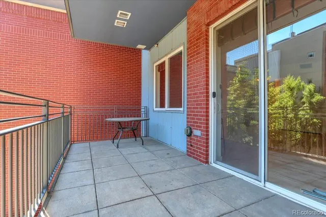 a view of a brick wall with an outdoor space