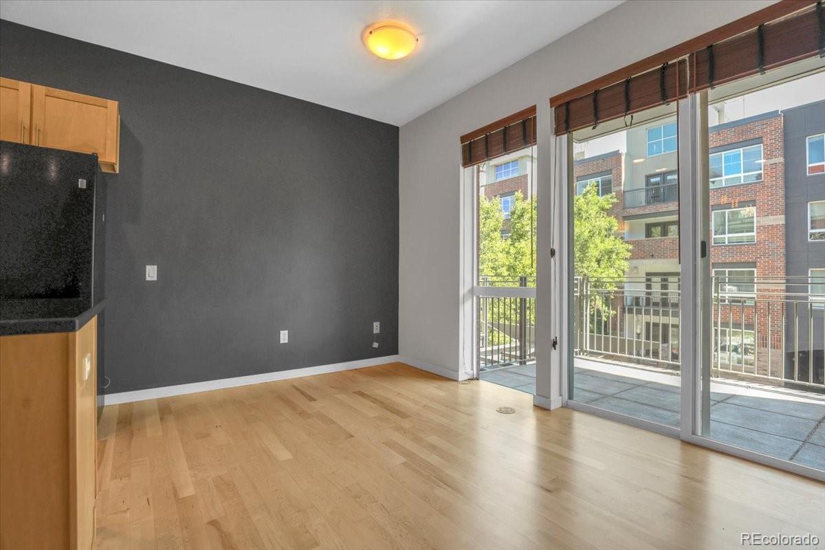 1438 Little Raven Street, Unit 201 Denver, CO 80202 - Photo 14 of 27 a view of an empty room with wooden floor and a window