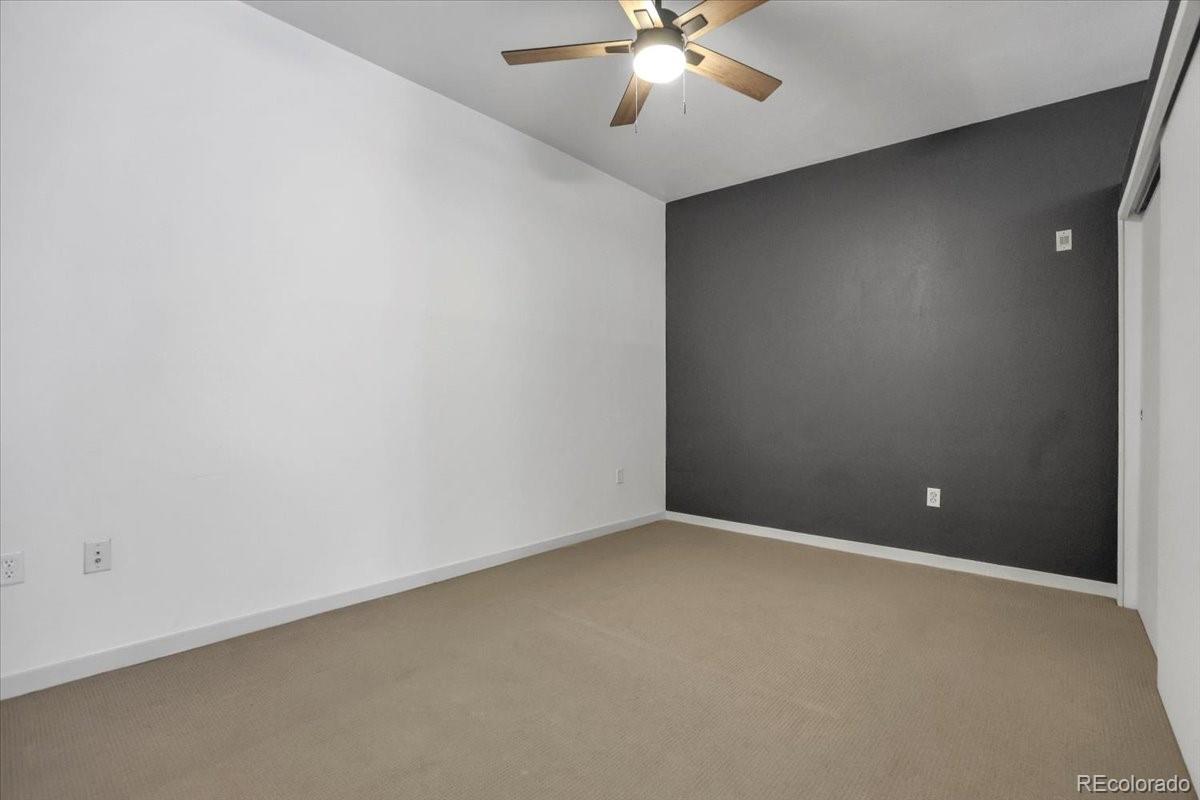 1438 Little Raven Street, Unit 201 Denver, CO 80202 - Photo 18 of 27 a view of an empty room with a chandelier fan