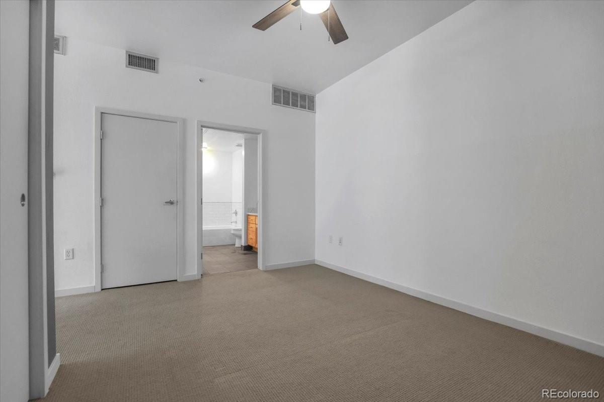 1438 Little Raven Street, Unit 201 Denver, CO 80202 - Photo 19 of 27 an empty room with chandelier fan