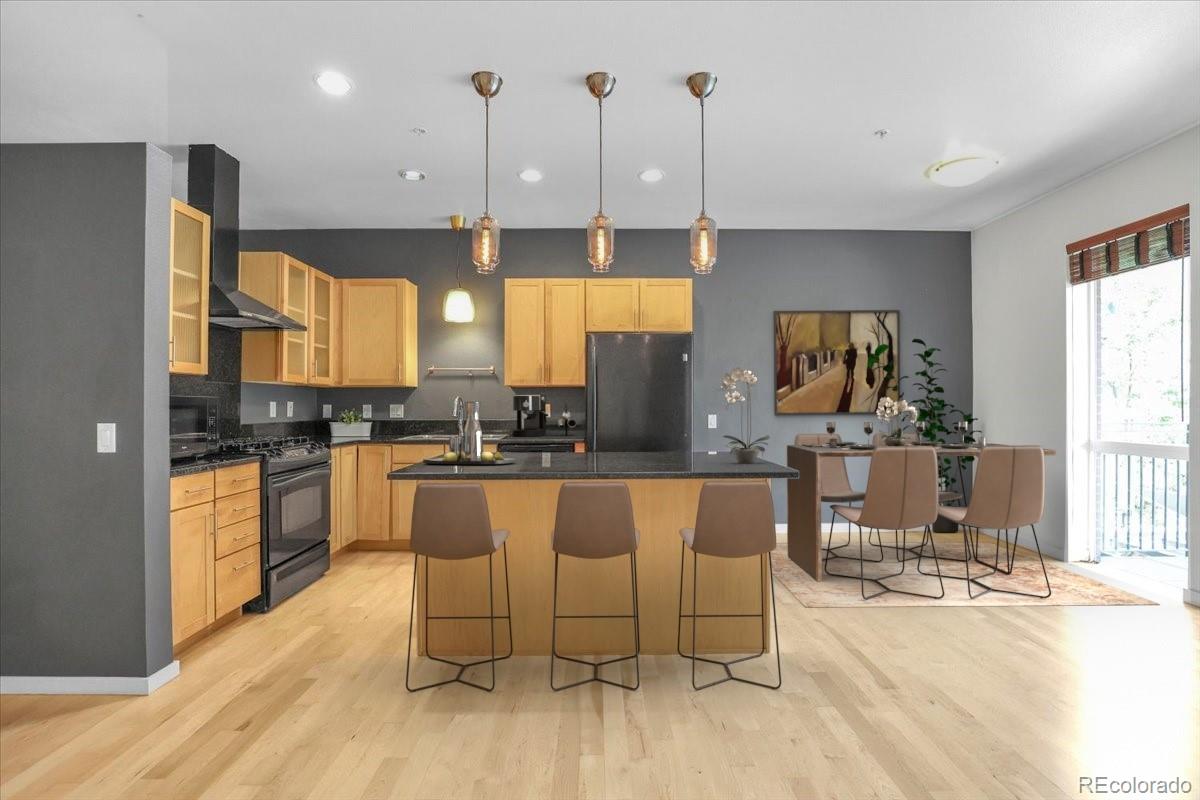 1438 Little Raven Street, Unit 201 Denver, CO 80202 - Photo 2 of 27 a large kitchen with a large window and stainless steel appliances