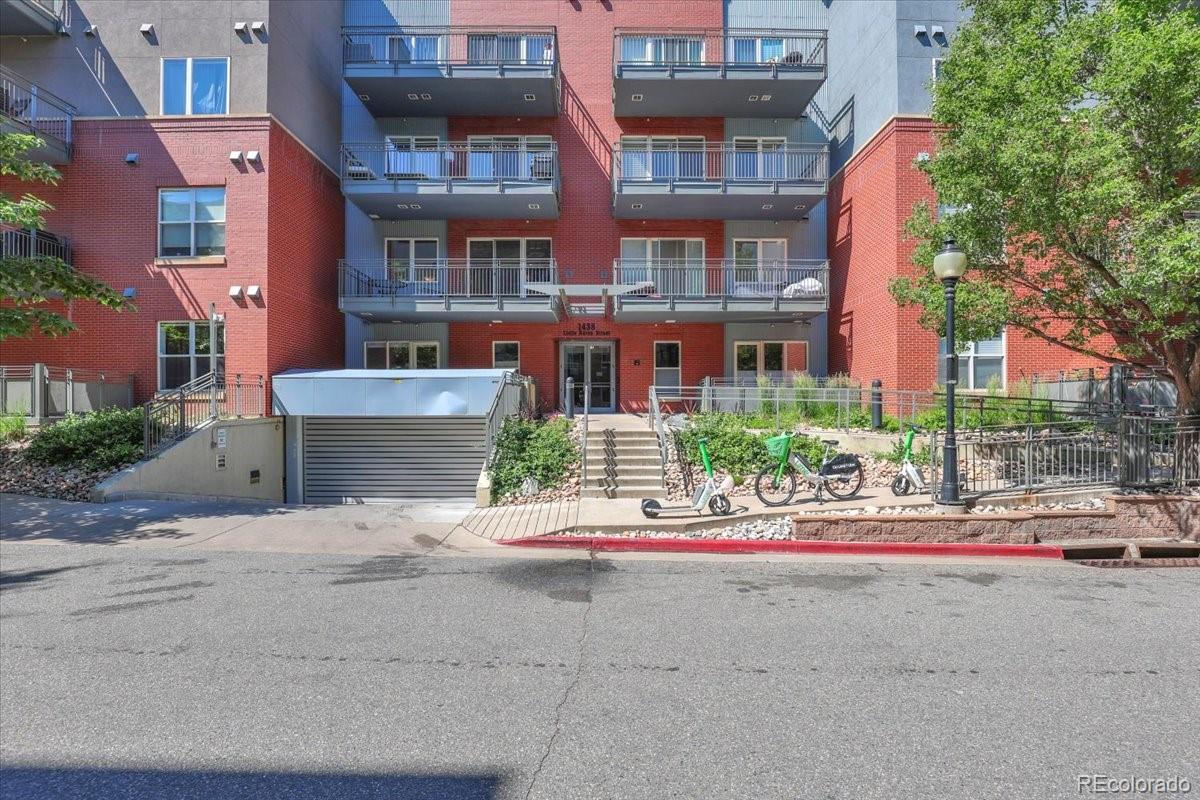 1438 Little Raven Street, Unit 201 Denver, CO 80202 - Photo 22 of 27 a view of building with cars parked in front of it