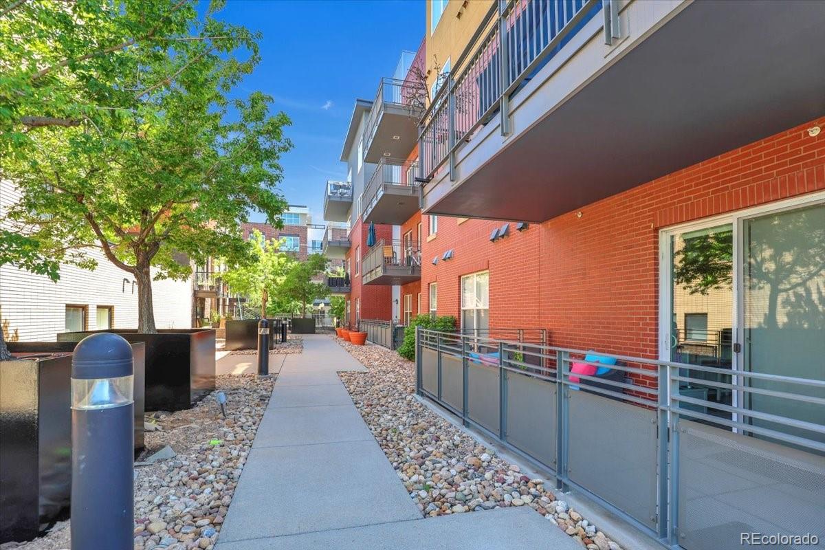 1438 Little Raven Street, Unit 201 Denver, CO 80202 - Photo 27 of 27 a city street lined with tall buildings
