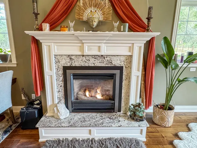 a living room with furniture and a fireplace