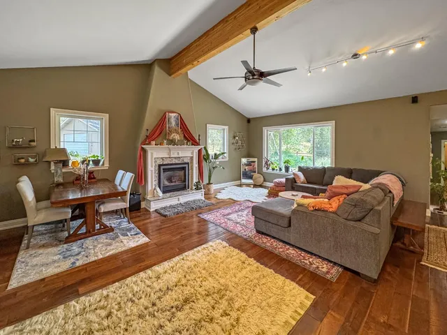 a living room with furniture a fireplace and a flat screen tv