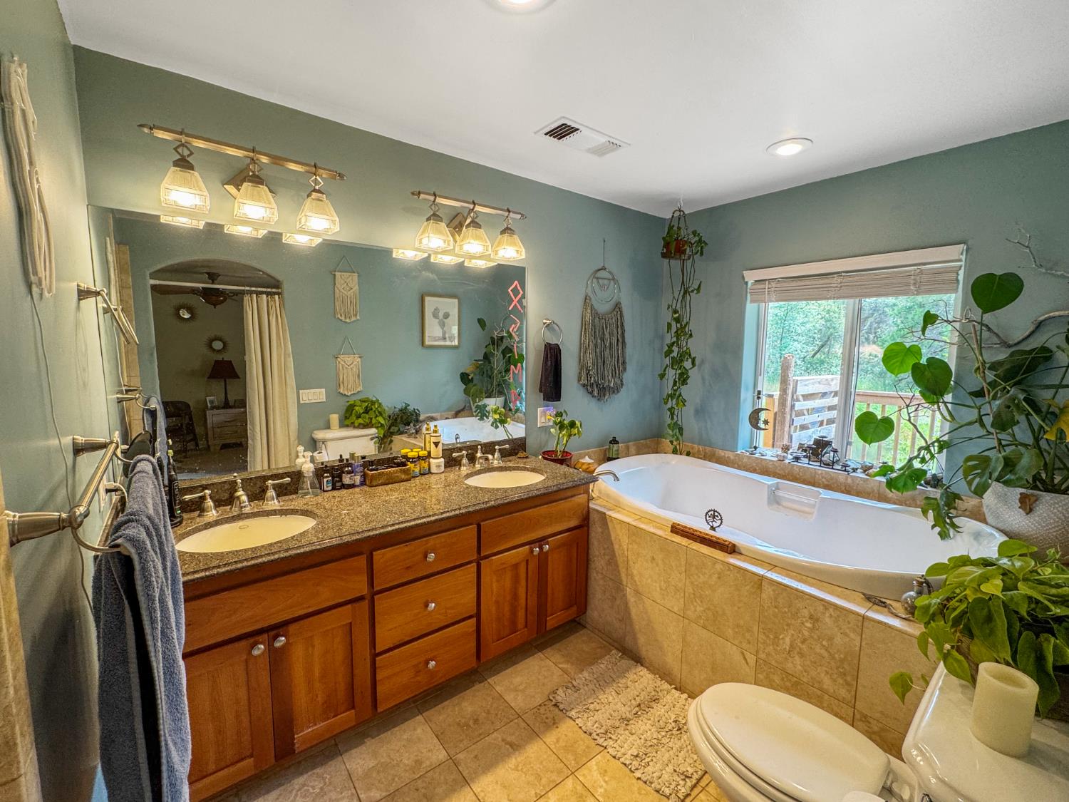15655 Rough And Ready Highway Rough and Ready, CA 95975 - Photo 22 of 48 a spacious bathroom with a granite countertop sink mirror vanity bathtub and toilet