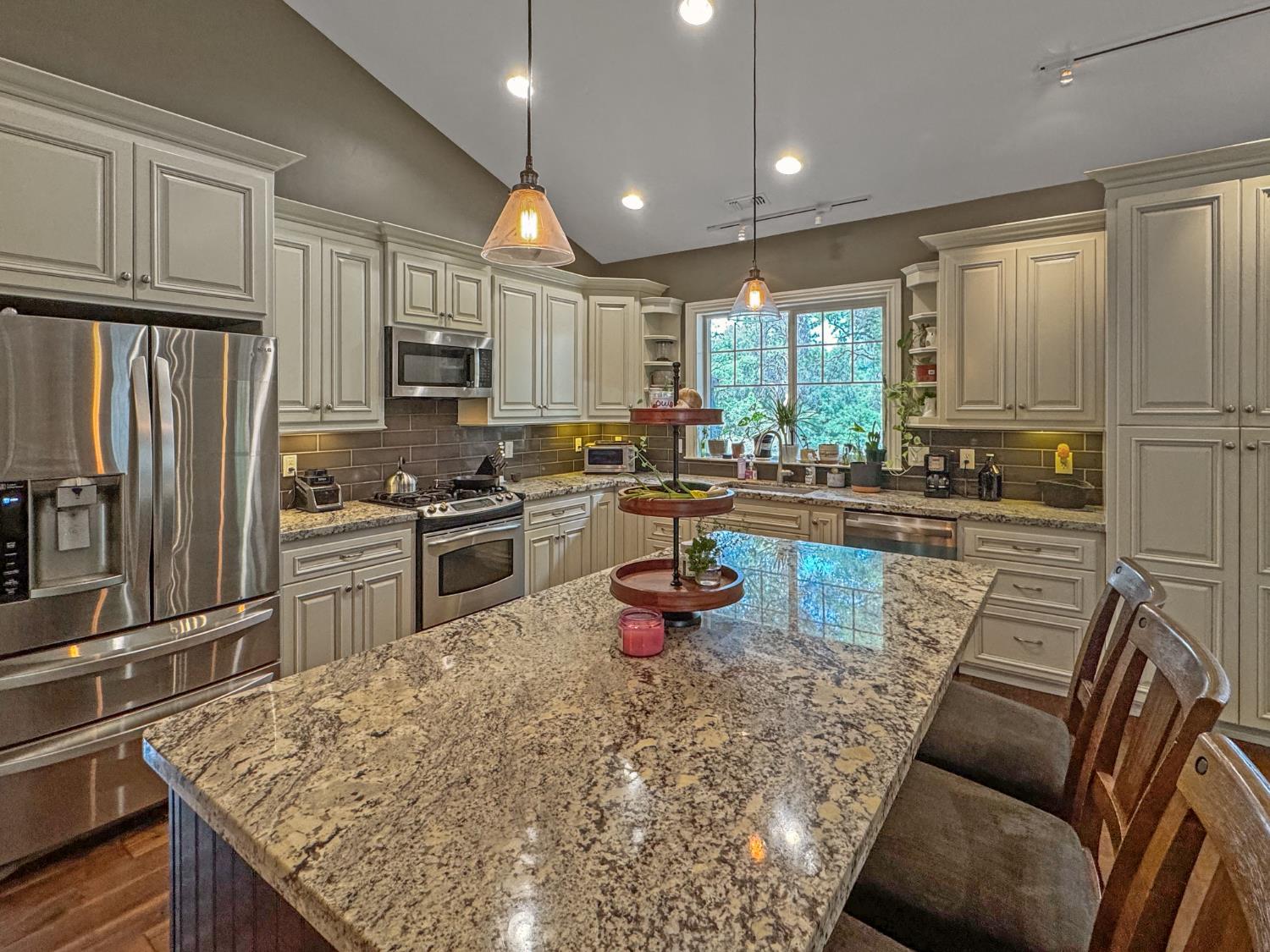 15655 Rough And Ready Highway Rough and Ready, CA 95975 - Photo 7 of 48 a kitchen with stainless steel appliances granite countertop a refrigerator sink stove dining table and chairs