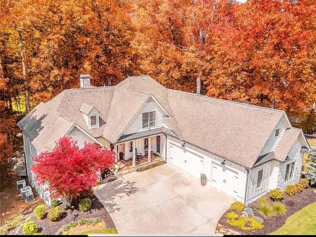 a view of a white house with a yard