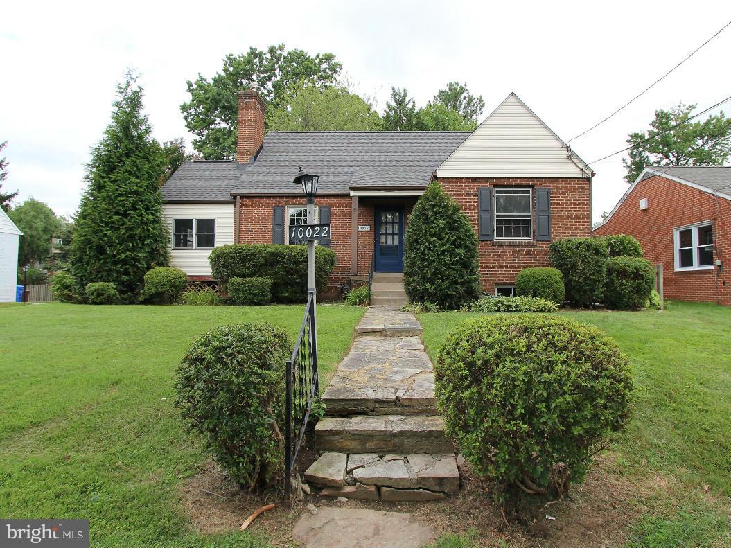 10022 Dallas Avenue Silver Spring, MD 20901 - Photo 1 of 30 a front view of a house with a yard and potted plants