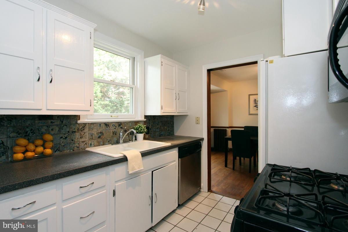 10022 Dallas Avenue Silver Spring, MD 20901 - Photo 11 of 30 a kitchen with a sink stove and cabinets