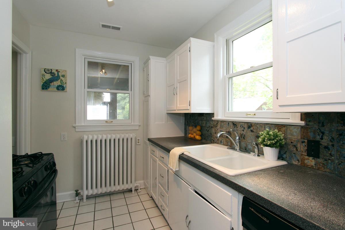 10022 Dallas Avenue Silver Spring, MD 20901 - Photo 12 of 30 a kitchen with a sink cabinets and window