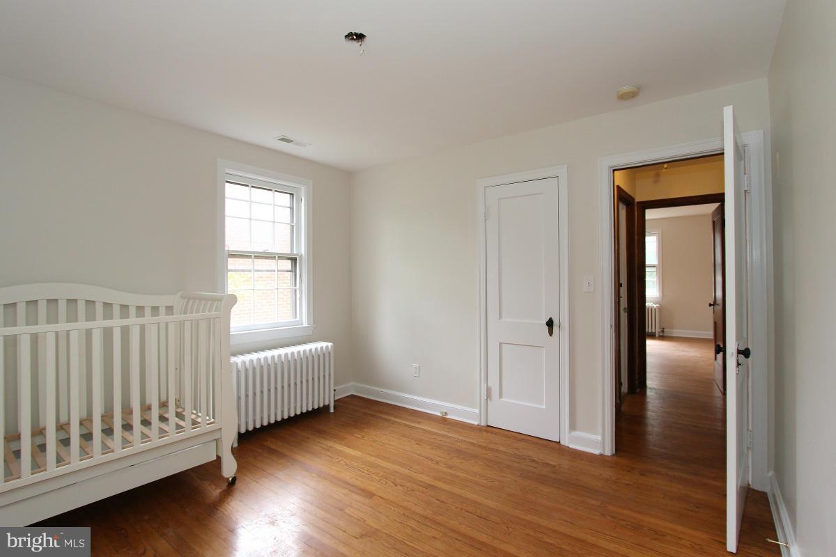 10022 Dallas Avenue Silver Spring, MD 20901 - Photo 16 of 30 an empty room with wooden floor and windows