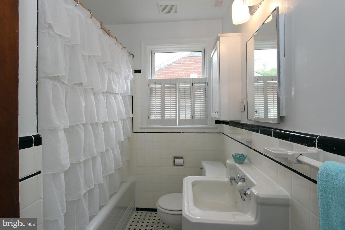 10022 Dallas Avenue Silver Spring, MD 20901 - Photo 17 of 30 a bathroom with a sink toilet and shower