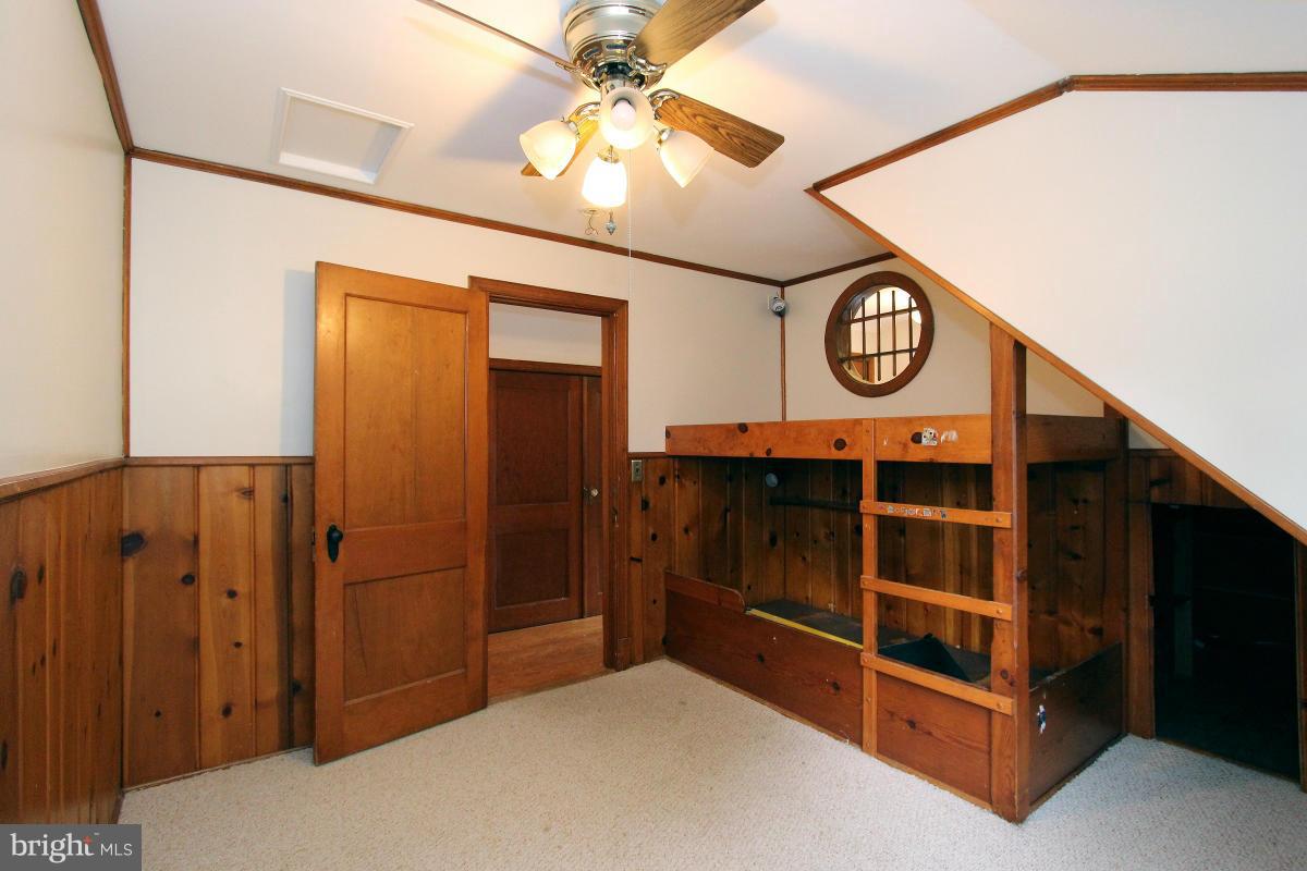 10022 Dallas Avenue Silver Spring, MD 20901 - Photo 19 of 30 a bedroom with a bed and a chandelier